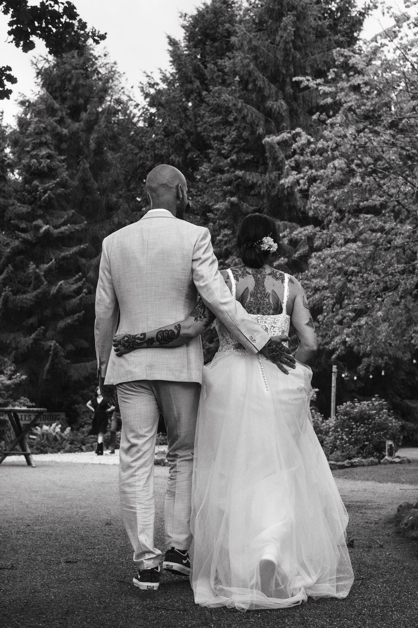 Newlyweds walking away with their arms around each other
