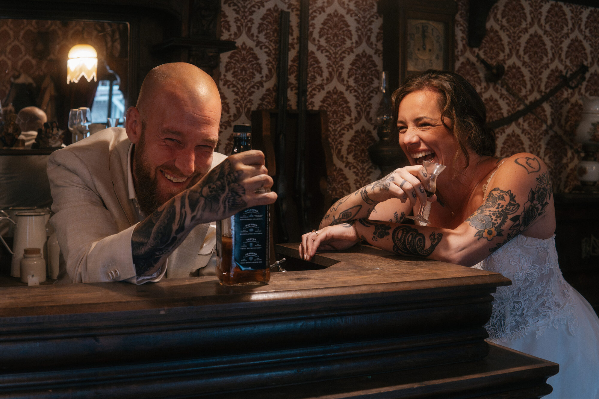 Newlyweds laughing together at the bar